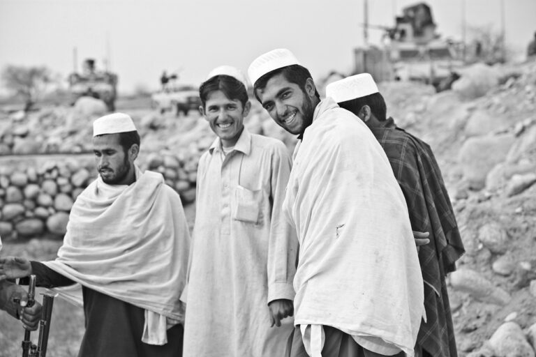 Four Afghan men gathered outdoors